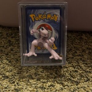 Pokemon Mewtwo Collectible with Card Display and large stack of Pokémon Cards